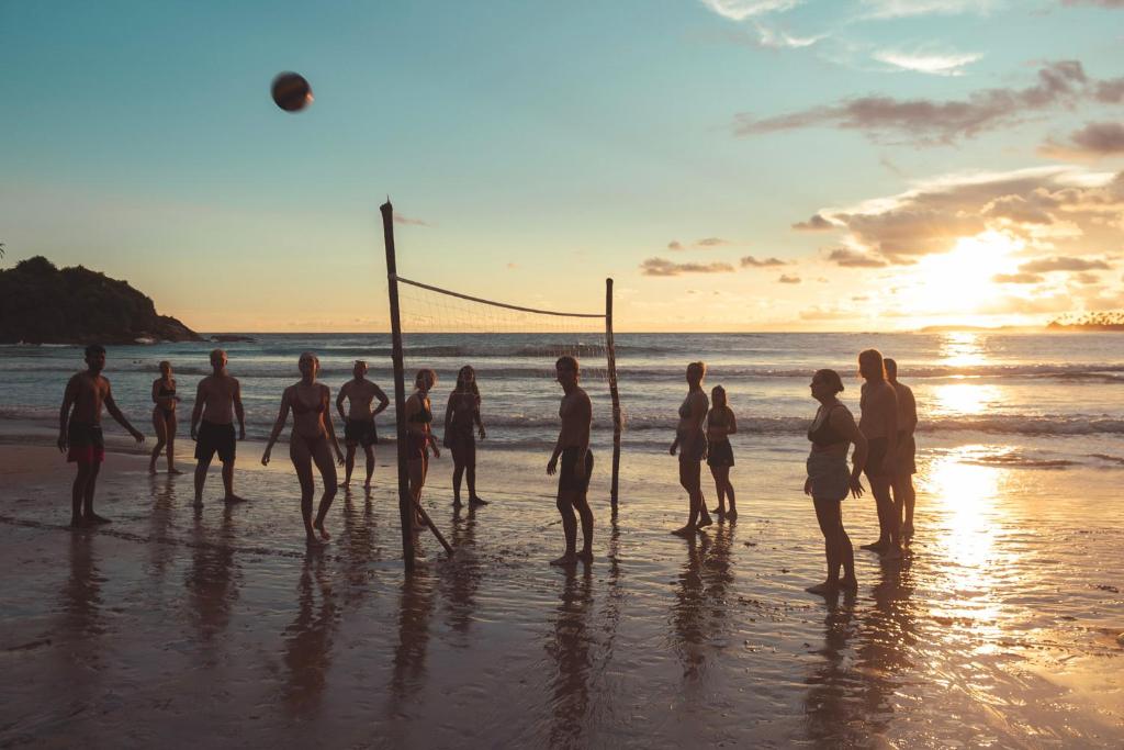 Happy Hammocks — beach volleyball at sunset